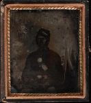 Unknown photographer Three quarter portrait, young soldier seated, in Union uniform with kepi; tents (possibly painted backdrop) in background. Cased tintype, sixth plate