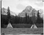 G707. Cut Bank Canyon Camp. Two Lodges. One Peak. Storm Clouds.