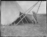 F809a. Priests and Sacred Woman at Sacred Lodge. Priest Entering Tipi.
