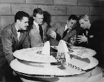 Louis I. Kahn, Visiting Critic in Architectural Design, and three students with an architectural model.