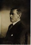 Woodrow Wilson, seated.