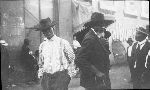 Black men walking on a street, undated.
