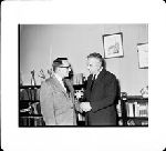 Dr. Bernard Rogowski (right) receving congraluations of The Reverend Sidney Lovett, retired chaplain.