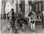 Three students bicycling.