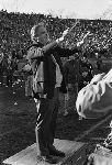 Yale president A. Bartlett Giamatti conducting the Yale Precision Marching Band at a football game in the Yale Bowl.