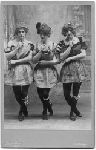 Three male students dressed as ladies for dramatic production.