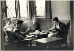 Male students reading, smoking and drinking coffee.