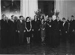 Chief Justice Earl Warren administers the oath of office to fifteen sub-Cabinet appointees, including Cyrus Vance (far right) as general counsel for the Defense Department.
