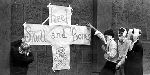 Four students displaying banner, "Heel Skull and Bones.