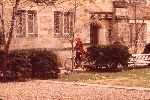 Female student riding a bicycle in Jonathan Edwards College.