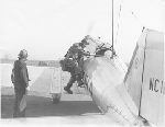 Charles A. Lindbergh climbing into a TWA Northrop airmail plane, February 21, 1933.