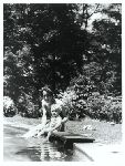 Charles A. Lindbergh Jr. and Anne Morrow Lindbergh sitting poolside.