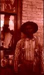 Man in a striped shirt in front of a window.