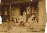 Family seated on the front porch.
