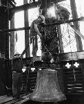 Installation of the bells in Harkness Tower with an exterior clock visible.